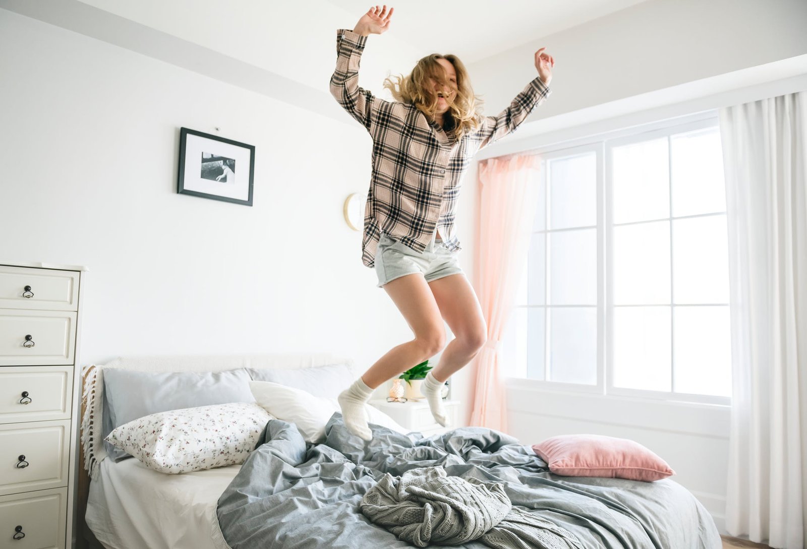 Woman jumping on the bed