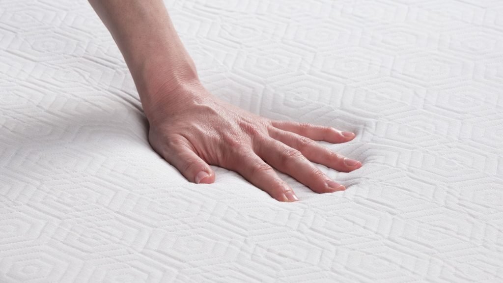 A lady pressing down on the foam surface
